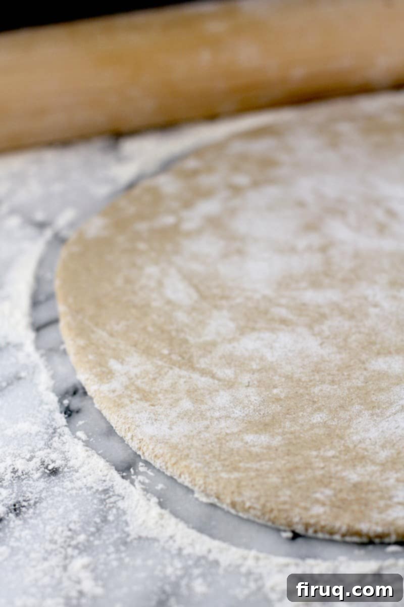 Healthy Whole Wheat Pizza Dough 9 the dough rolled out with on a marble surface