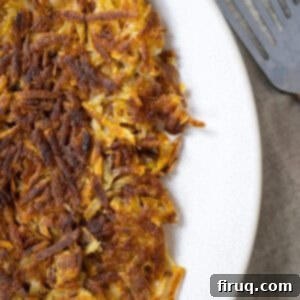 Crispy Hash Browns Perfection 12 Crispy fried hash browns on a plate, hot and ready to eat.