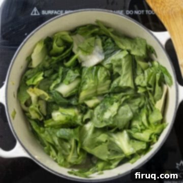 Hearty Escarole and Bean Soup 6 Freshly chopped escarole added to the Dutch oven, mixing with the sautéed garlic and olive oil before wilting down.