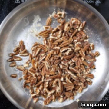 Decadent Bourbon Candied Pecans 4 Toasting pecans in a saucepan.