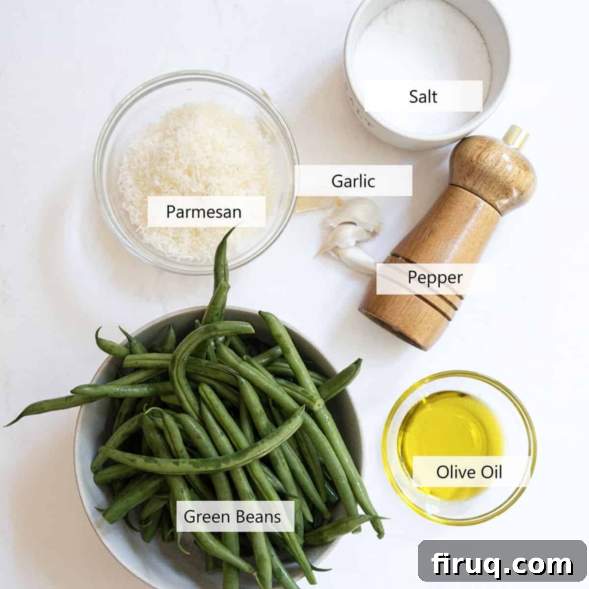 Mouthwatering Garlic Parmesan Green Beans 3 Fresh ingredients for garlic parmesan green beans, including vibrant green beans, garlic cloves, and a block of Parmesan cheese.
