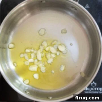 Mouthwatering Garlic Parmesan Green Beans 6 Sliced garlic gently sautéing in shimmering olive oil in a pan.
