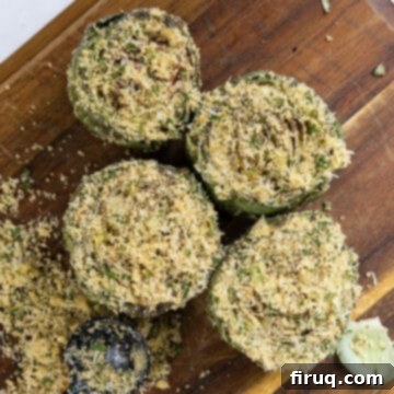 Simple Italian Stuffed Artichokes 7 Artichokes on a cutting board stuffed with breadcrumbs and parmesan.