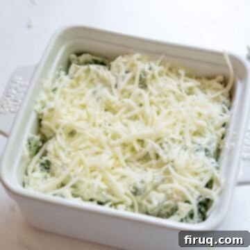 Guilt-Free Creamy Spinach Artichoke Dip 7 Spinach and artichoke dip topped with mozzarella.