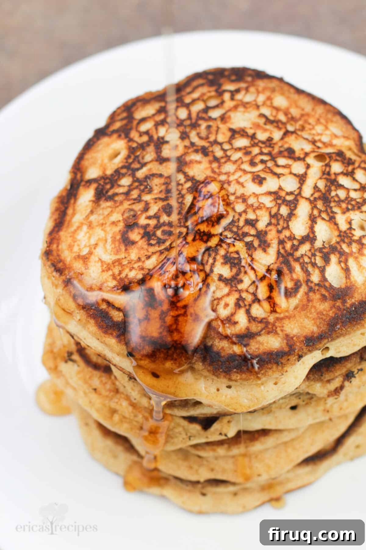 Fluffy Cinnamon Applesauce Pancakes 9 syrup pouring on stack of pancakes, top down view