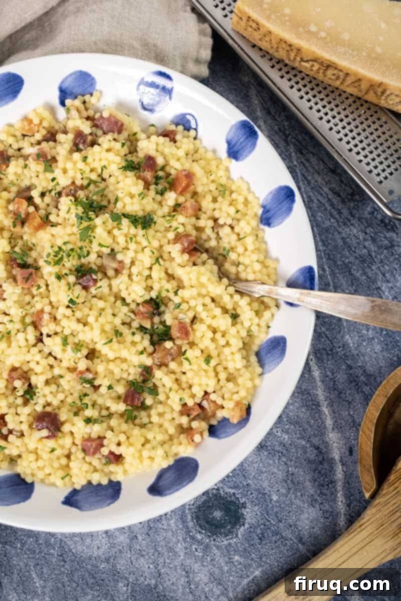 Classic Pastina Carbonara 2 Pastina with crispy pancetta and fresh parsley in a beautiful white bowl, ready to be served.