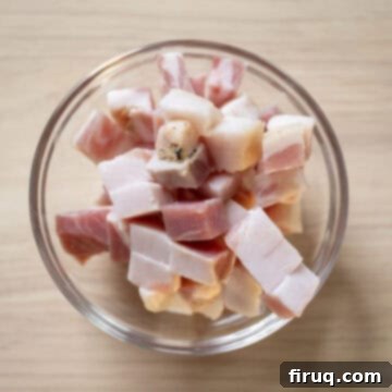 Classic Pastina Carbonara 4 Pancetta neatly chopped into ¼ inch pieces on a cutting board, ready for cooking.