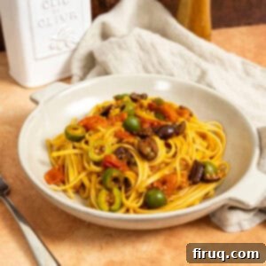 Rustic Linguine Alla Puttanesca 10 Linguine puttanesca topped with olives and capers in a bowl.