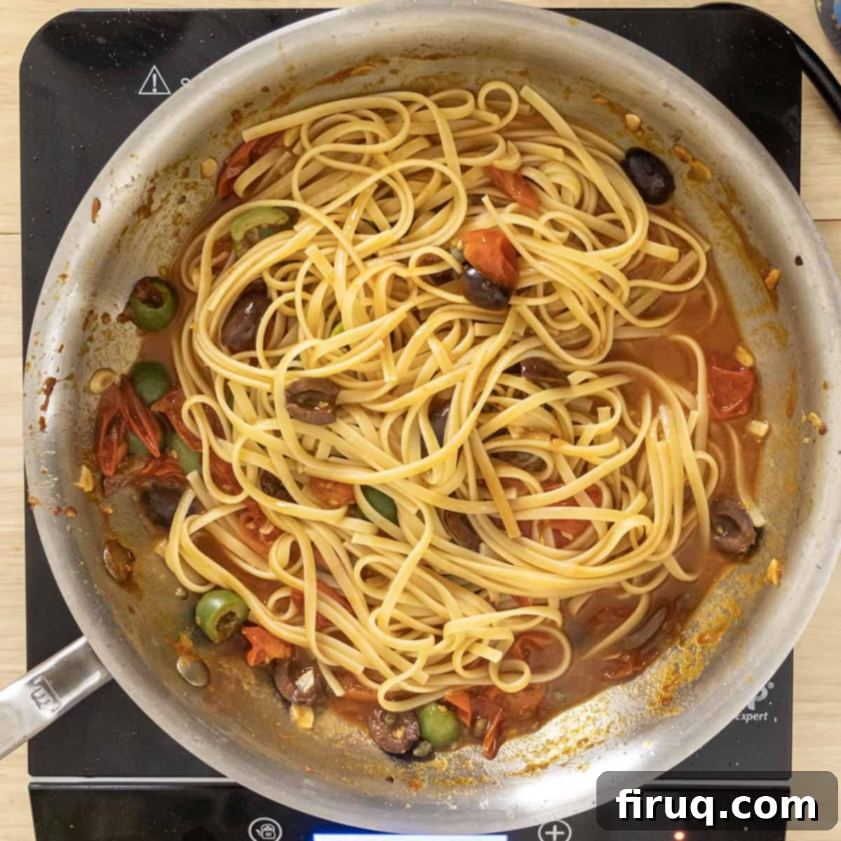 Rustic Linguine Alla Puttanesca 8 Al dente linguine pasta combined with the rich, aromatic puttanesca sauce in a pan, absorbing all the delicious flavors.