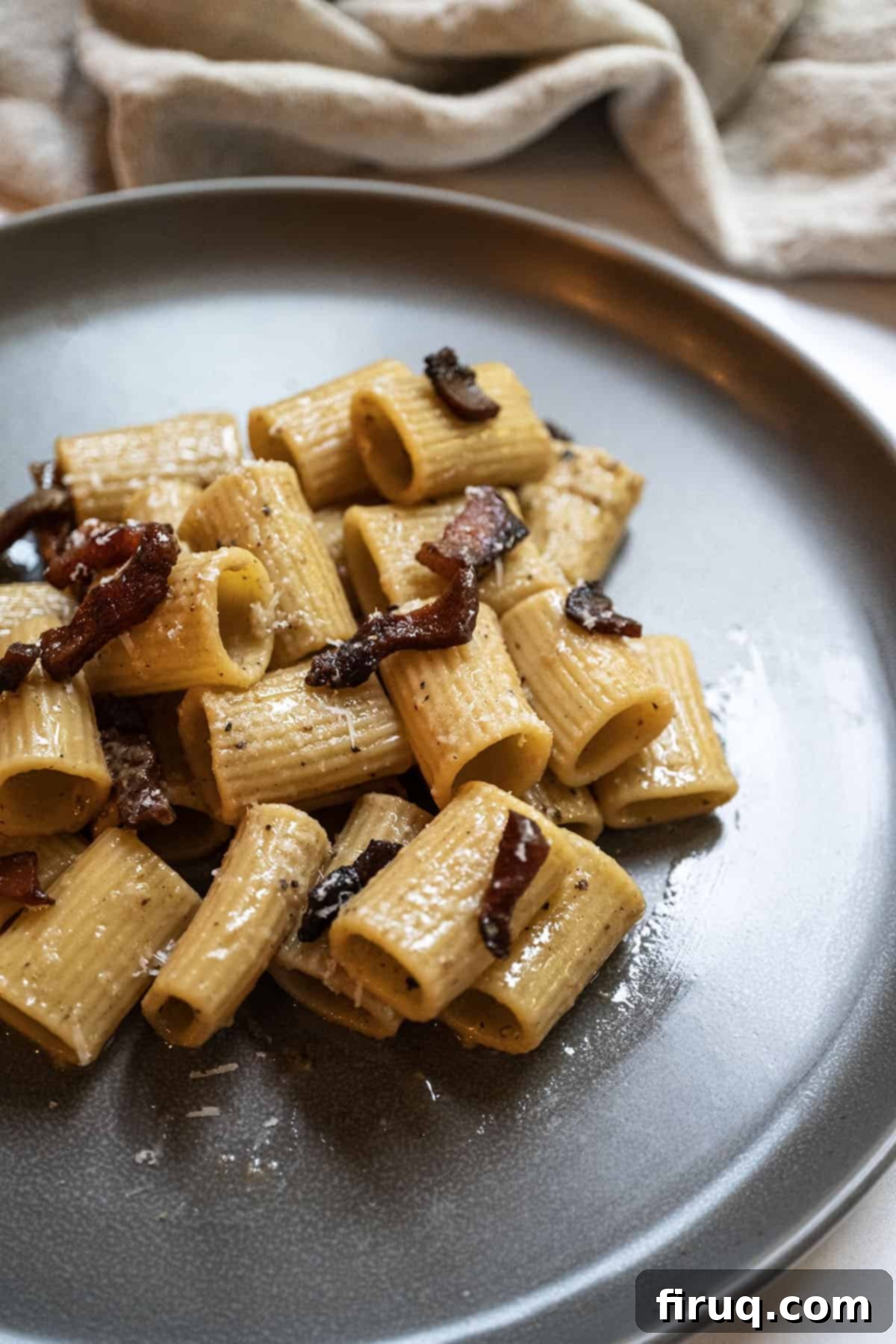 Roman Guanciale Pasta 2 Pasta alla gricia served on a plate and topped with guanciale.