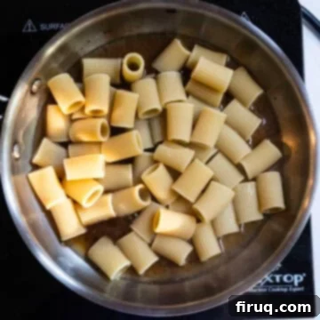 Roman Guanciale Pasta 8 Adding halfway cooked pasta to the pan.