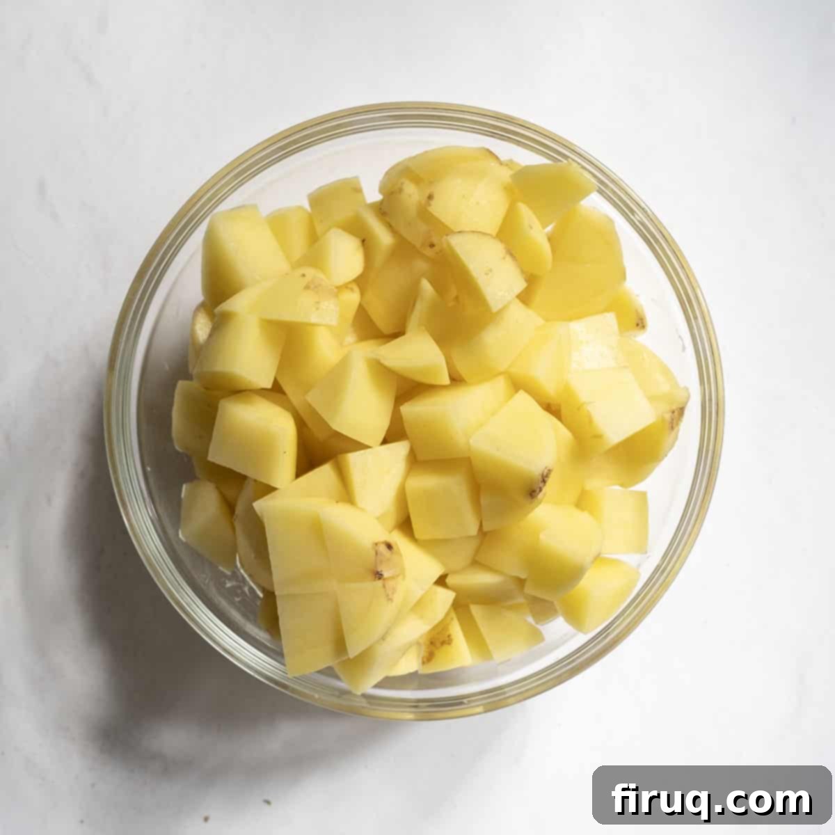 Velvety Potato and Onion Embrace 4 Potatoes chopped to ¾ inch pieces in a bowl.