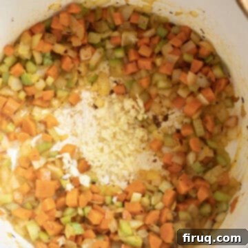 Velvety Potato and Onion Embrace 6 Garlic added to the pot with carrots, onion, and celery to saute.