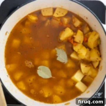 Velvety Potato and Onion Embrace 8 Potatoes added to pot with broth.