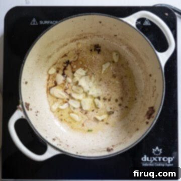 The Ultimate Homemade Italian Lasagna 6 Thinly sliced garlic cloves gently sizzling in a pool of olive oil in a Dutch oven, filling the kitchen with an inviting aroma.
