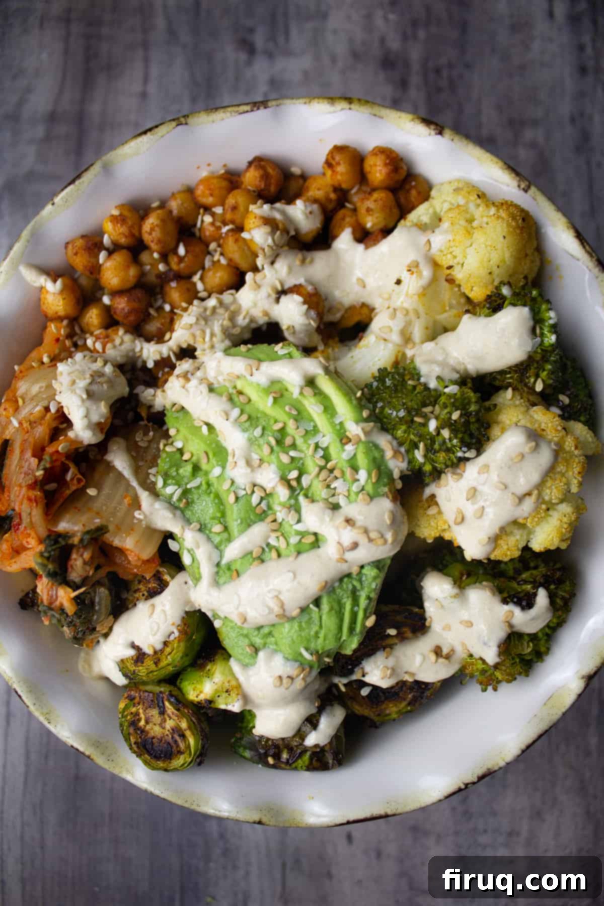 Crispy Chickpea Power Bowl 2 Delicious and healthy roasted chickpea veggie grain bowl with tahini sauce, broccoli, cauliflower, kimchi, and avocado