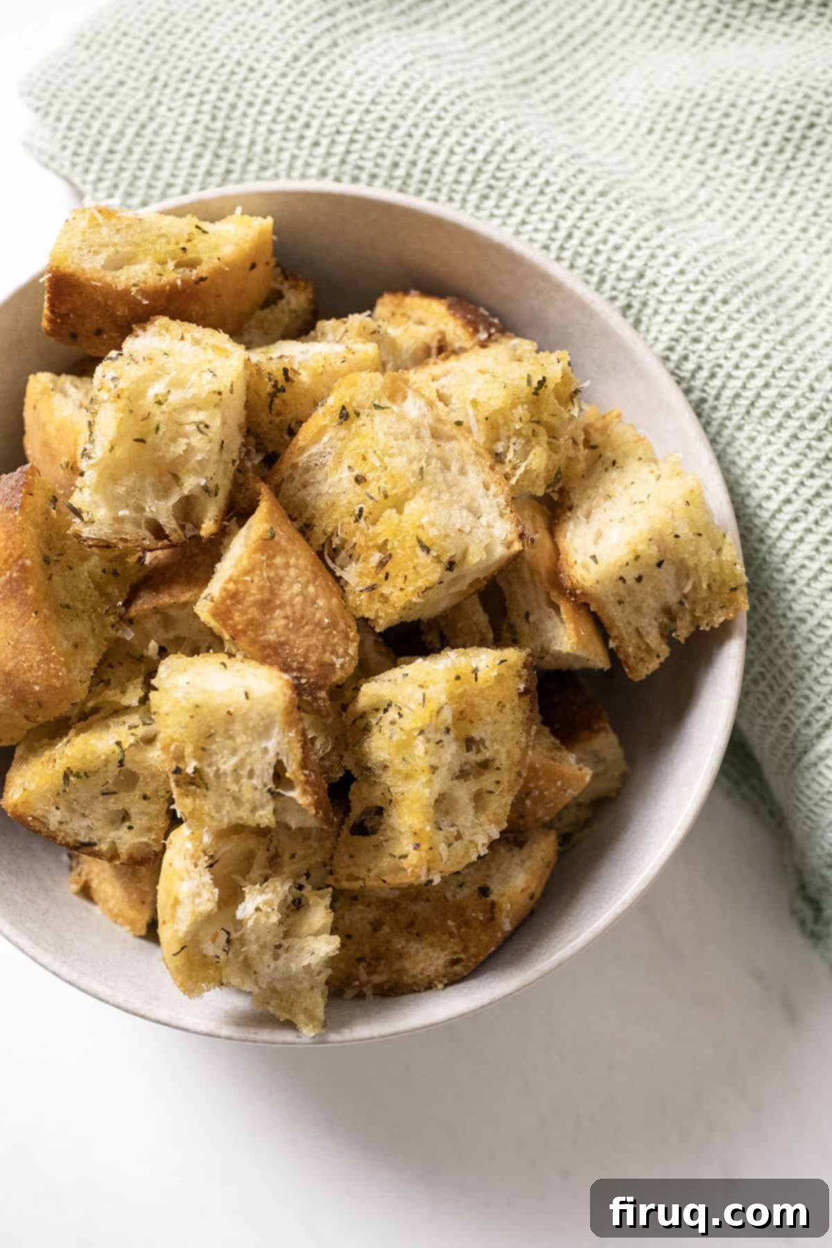 Crispy Homemade Parmesan Croutons 9 A large bowl generously filled with freshly prepared, crispy Parmesan seasoned croutons, ready for serving.