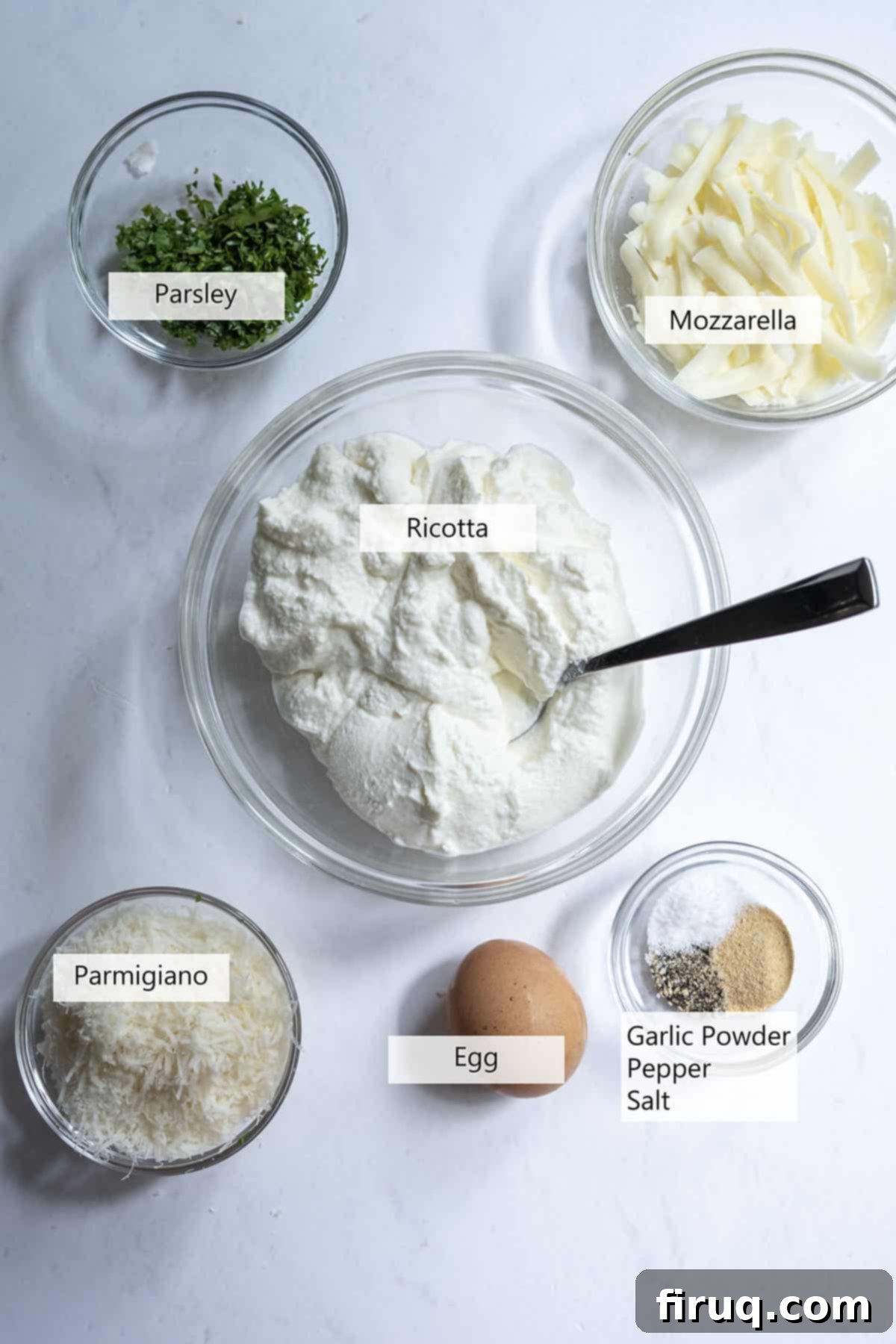 Creamy Ricotta Filling 3 Fresh ingredients laid out for making a creamy ricotta mixture: whole milk ricotta, grated mozzarella, parmesan, an egg, fresh parsley, and garlic.