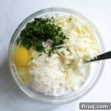 Creamy Ricotta Filling 4 A large mixing bowl containing ricotta cheese, eggs, grated mozzarella, fresh parsley, and parmesan cheese, ready to be combined.