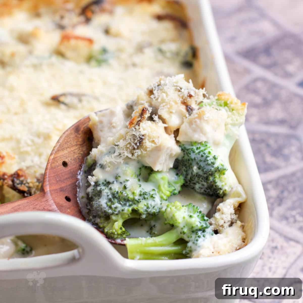 Creamy Chicken Broccoli Bake 11 wood spoon in casserole of Chicken Divan