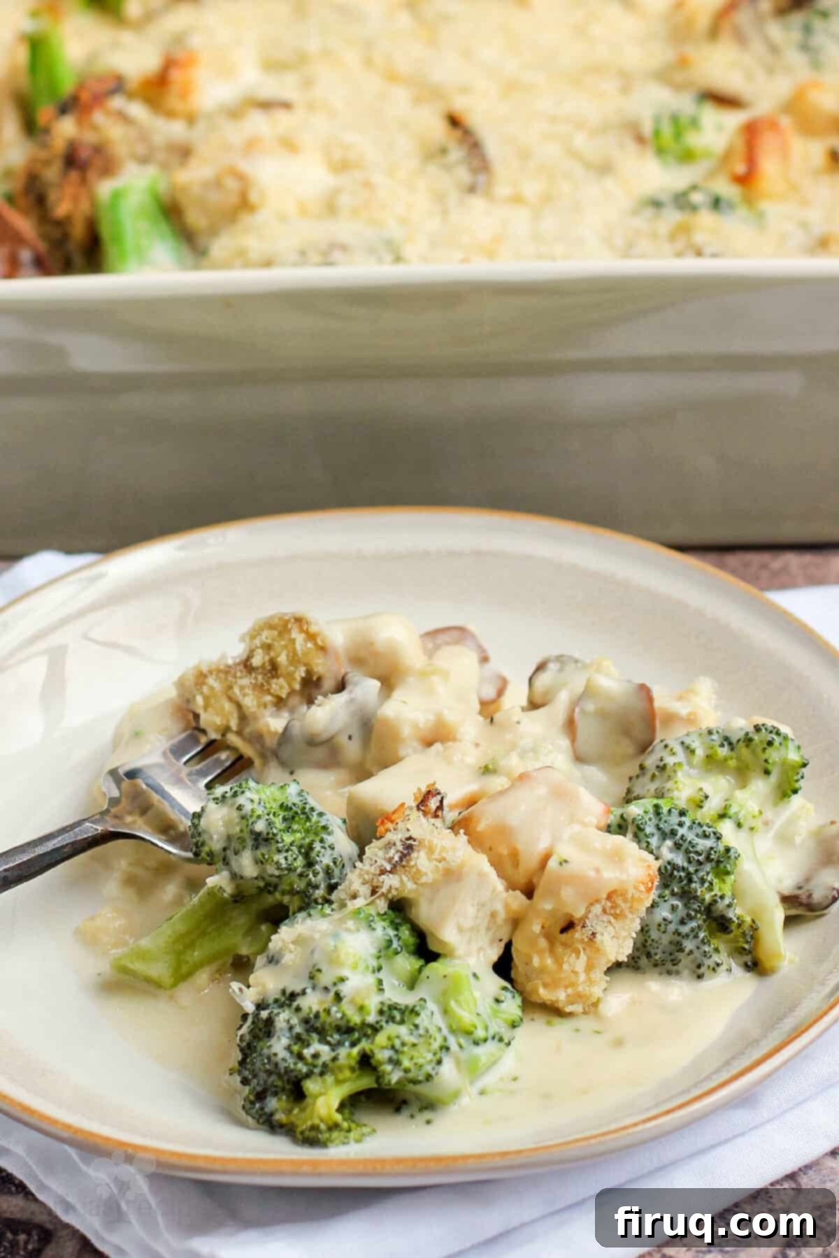Creamy Chicken Broccoli Bake 10 A generous serving of Chicken Divan presented on a white plate, ready to be enjoyed as a comforting meal.