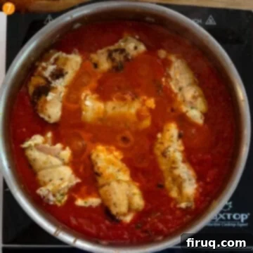 Chicken Rollatini 11 Chicken rollatini placed in the sauce to simmer.