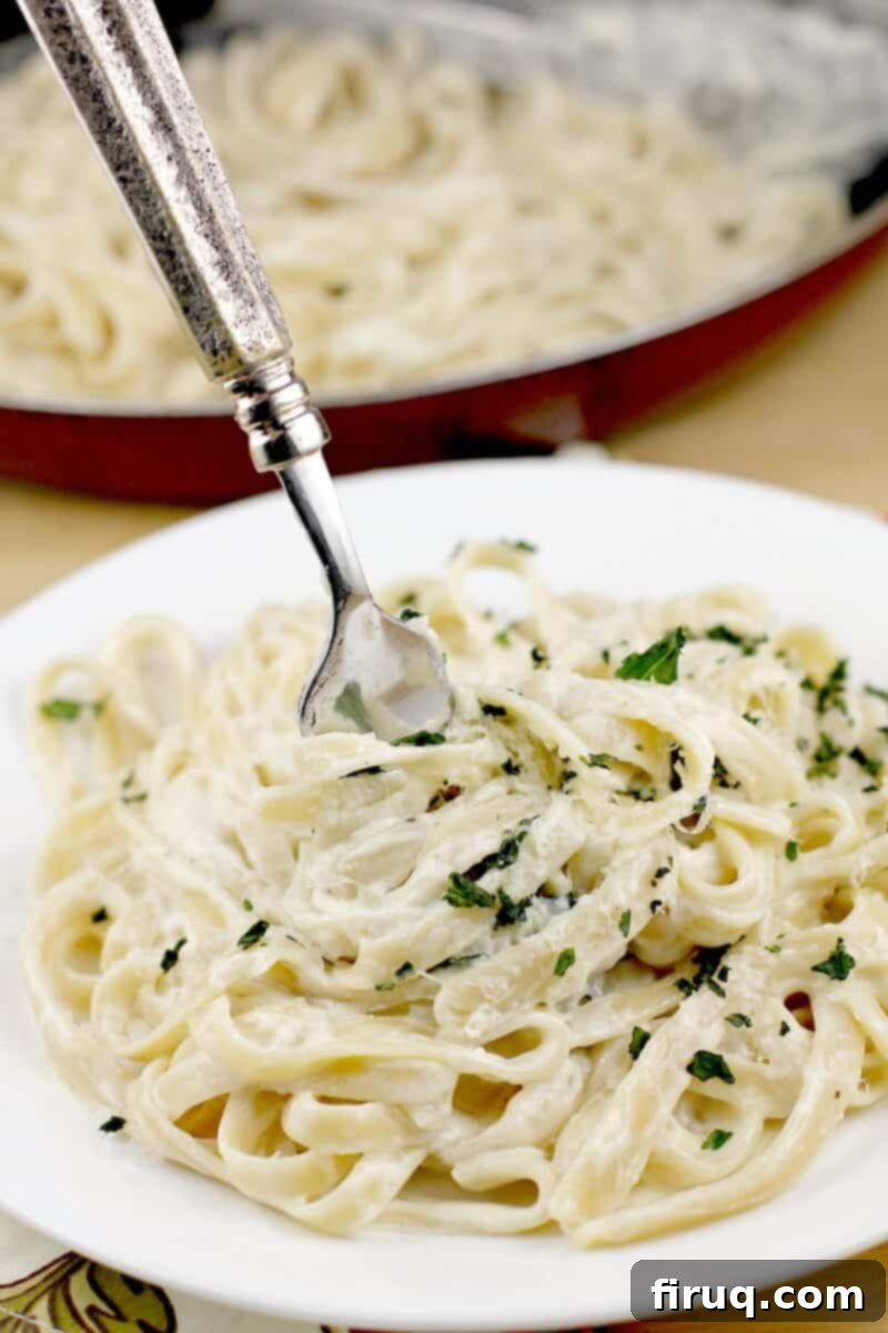 Fettuccine Alfredo 2 fork twirling up fettuccine alfredo