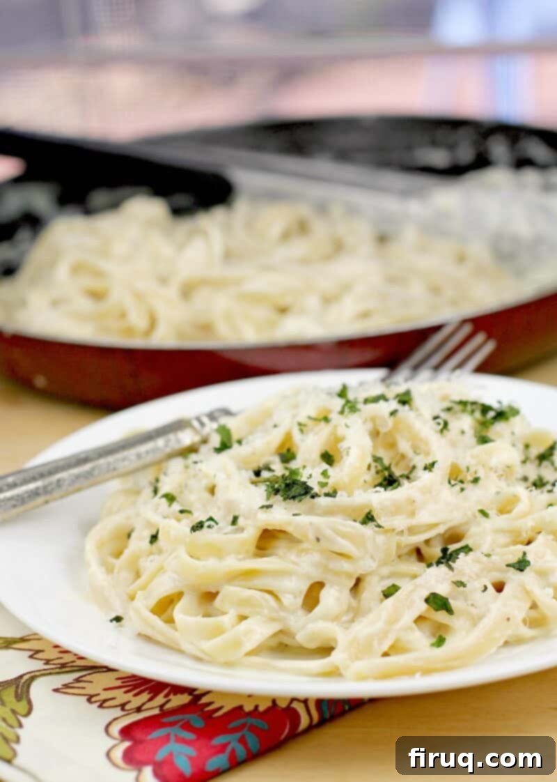 Fettuccine Alfredo 13 the plated recipe, skillet in the background