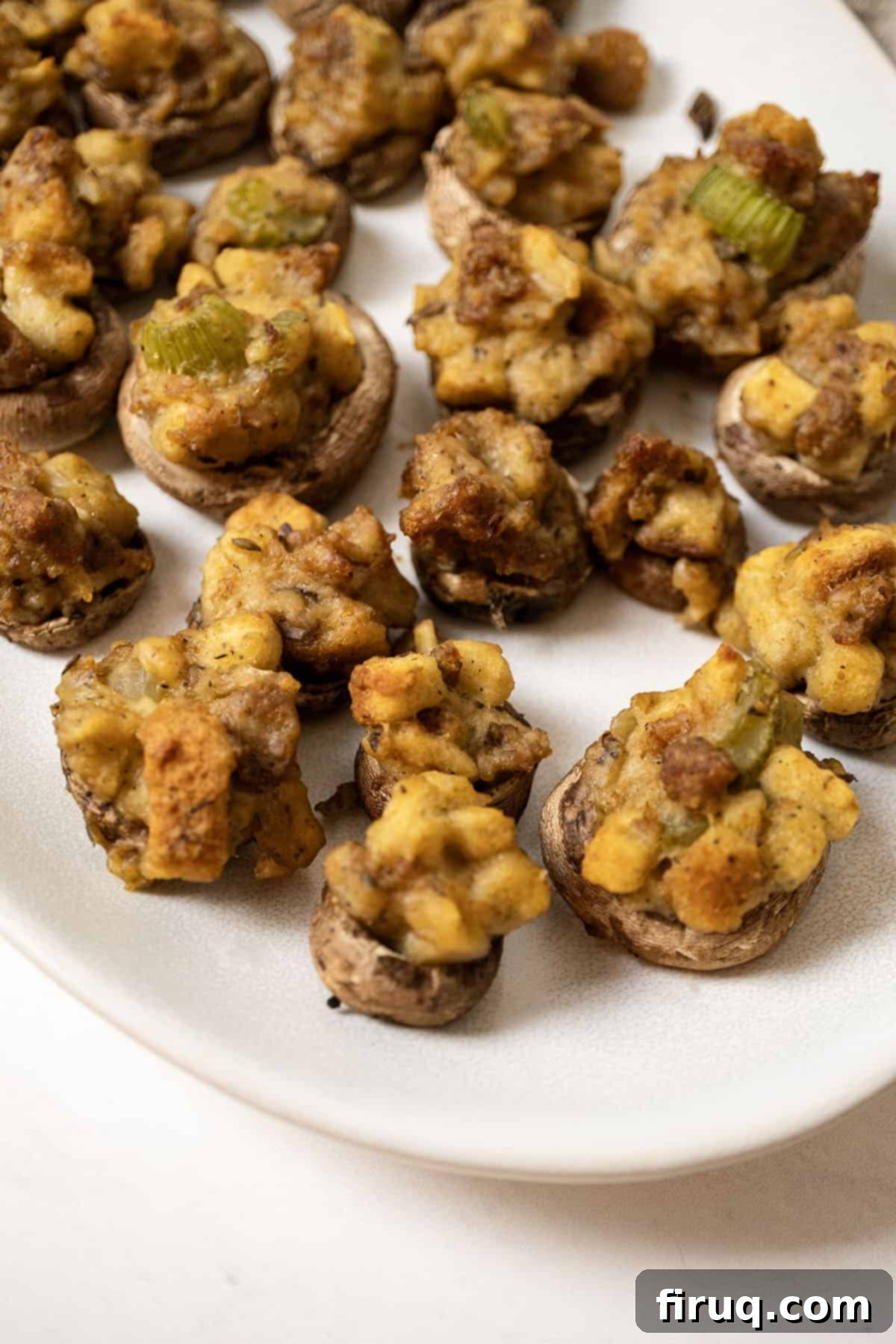 Gourmet Italian Sausage Stuffed Mushrooms 2 Stuffed Mushrooms on a plate.