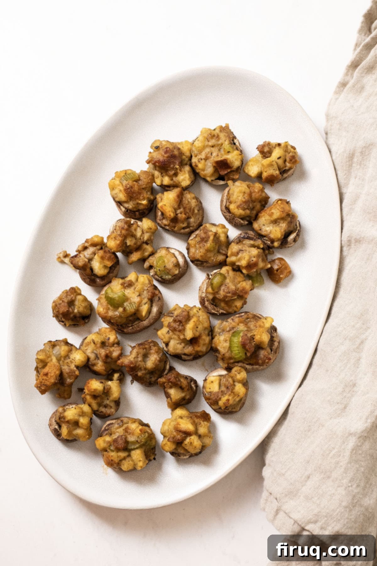 Gourmet Italian Sausage Stuffed Mushrooms 11 Stuffed Mushrooms on a plate.