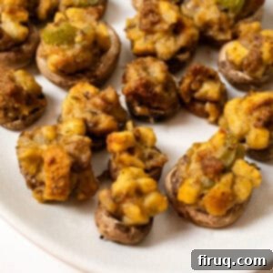 Gourmet Italian Sausage Stuffed Mushrooms 12 Stuffed Mushrooms on a plate.