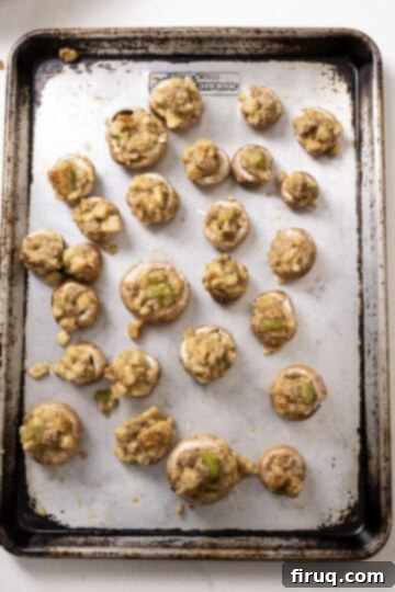 Gourmet Italian Sausage Stuffed Mushrooms 9 Mushrooms stuffed with stuffing on the baking sheet.
