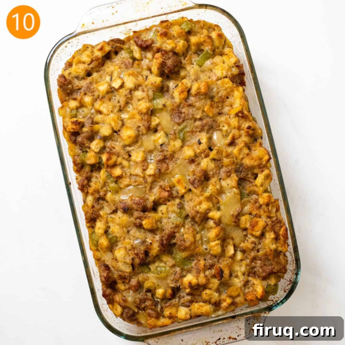 Robust Italian Sausage Thanksgiving Stuffing 11 The finished Thanksgiving Italian sausage stuffing, golden brown and perfectly baked in a glass baking pan, ready to be carved and served.