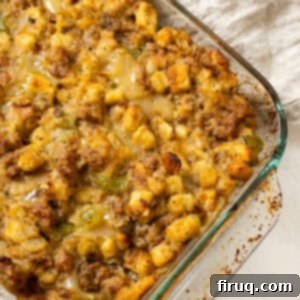 Robust Italian Sausage Thanksgiving Stuffing 13 Thanksgiving Italian sausage stuffing baked to perfection in a glass pan, showcasing its crispy golden top and savory filling.