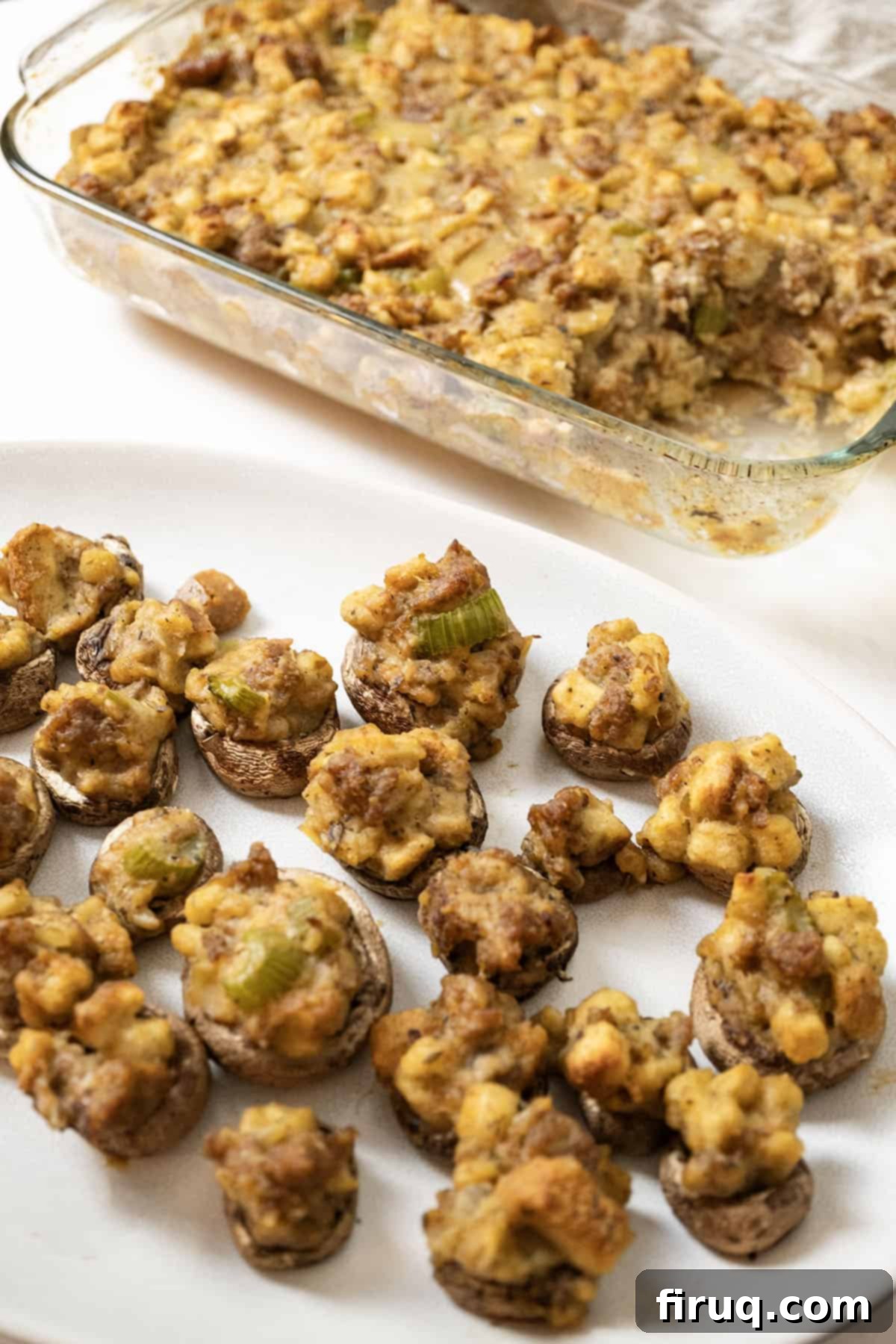 Robust Italian Sausage Thanksgiving Stuffing 3 Baked Italian sausage stuffing in a glass pan, with savory Italian sausage stuffed mushrooms in the background, making a complete holiday spread.