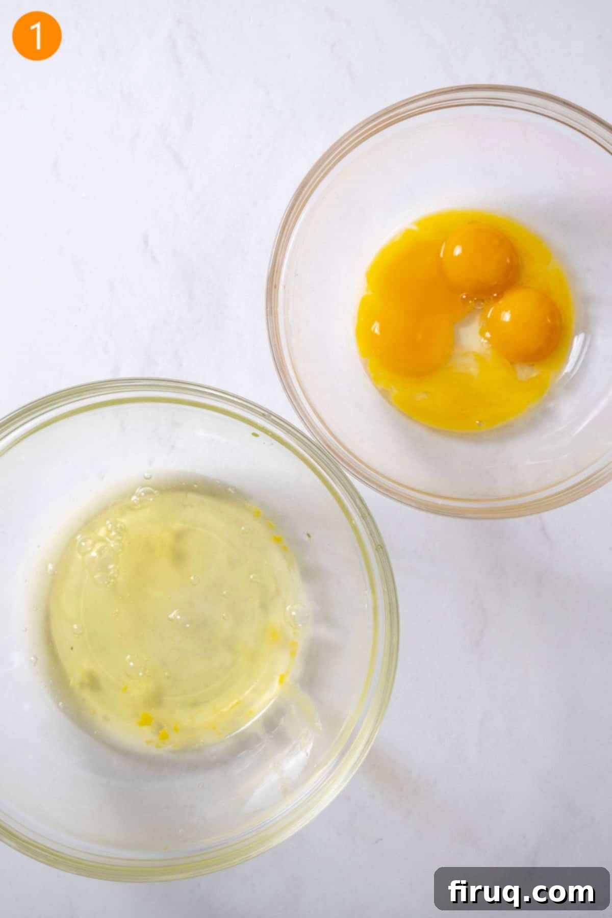 Homemade Ladyfingers for Perfect Tiramisu 4 Carefully separated egg yolks and egg whites in two distinct glass bowls, emphasizing preparation.