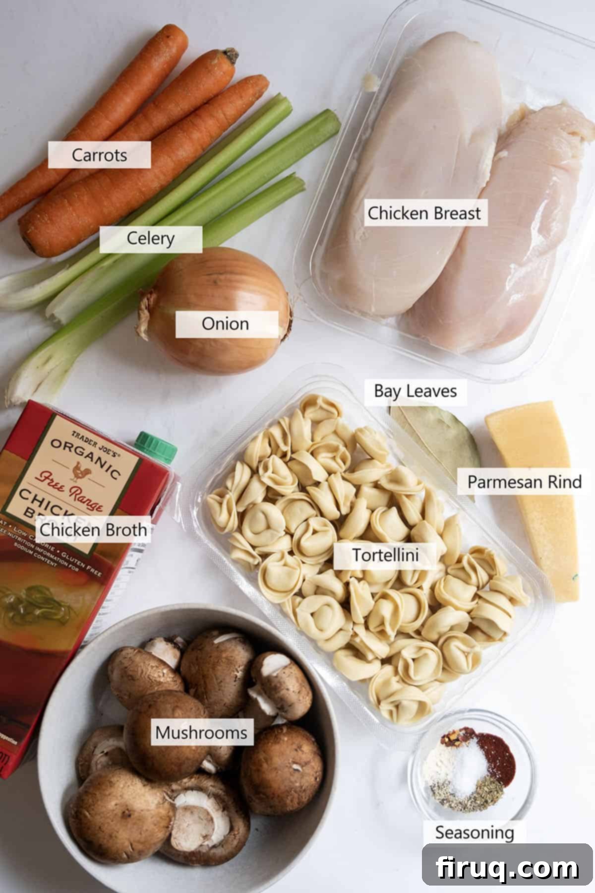 Creamy Chicken Tortellini Bliss 3 A flat lay of fresh ingredients for chicken tortellini soup, including chicken breasts, chopped vegetables, and spices.