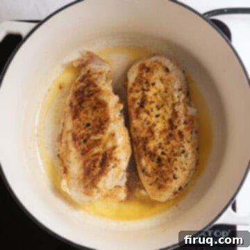 Creamy Chicken Tortellini Bliss 5 Searing seasoned chicken breasts until golden brown in a large pot with olive oil.