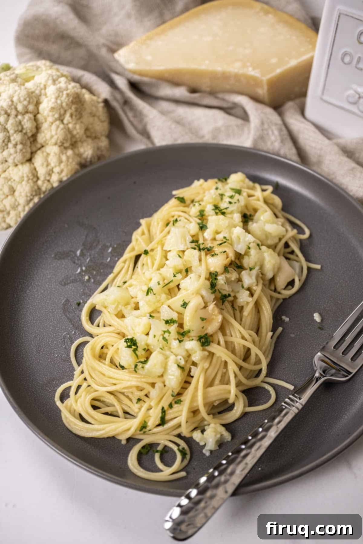 Roasted Cauliflower Pasta 2 spaghetti with cauliflower plated on a dish garnished with parsley.