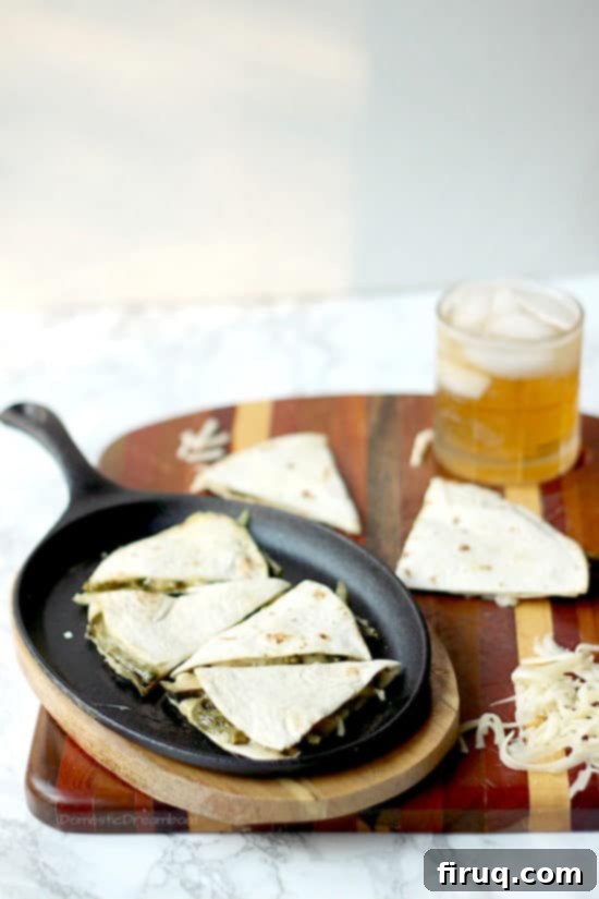 Easy Rajas con Crema Recipe A serving of Rajas con Crema Quesadillas, cut into wedges, showing the rich filling and beautifully melted cheese inside.