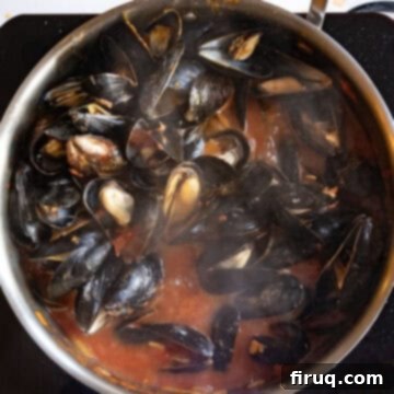 Devilishly Delicious Mussels 9 Perfectly steamed mussels, fully opened and glistening, coated in the fiery Fra Diavolo sauce, ready to be served as a stunning Italian appetizer.