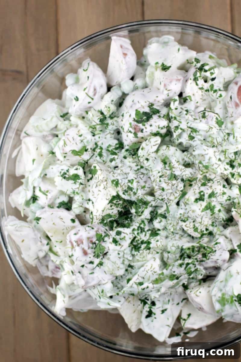 Spring Potato Salad with Zesty Dill 12 spring potato salad with sour cream and dill in a glass bowl