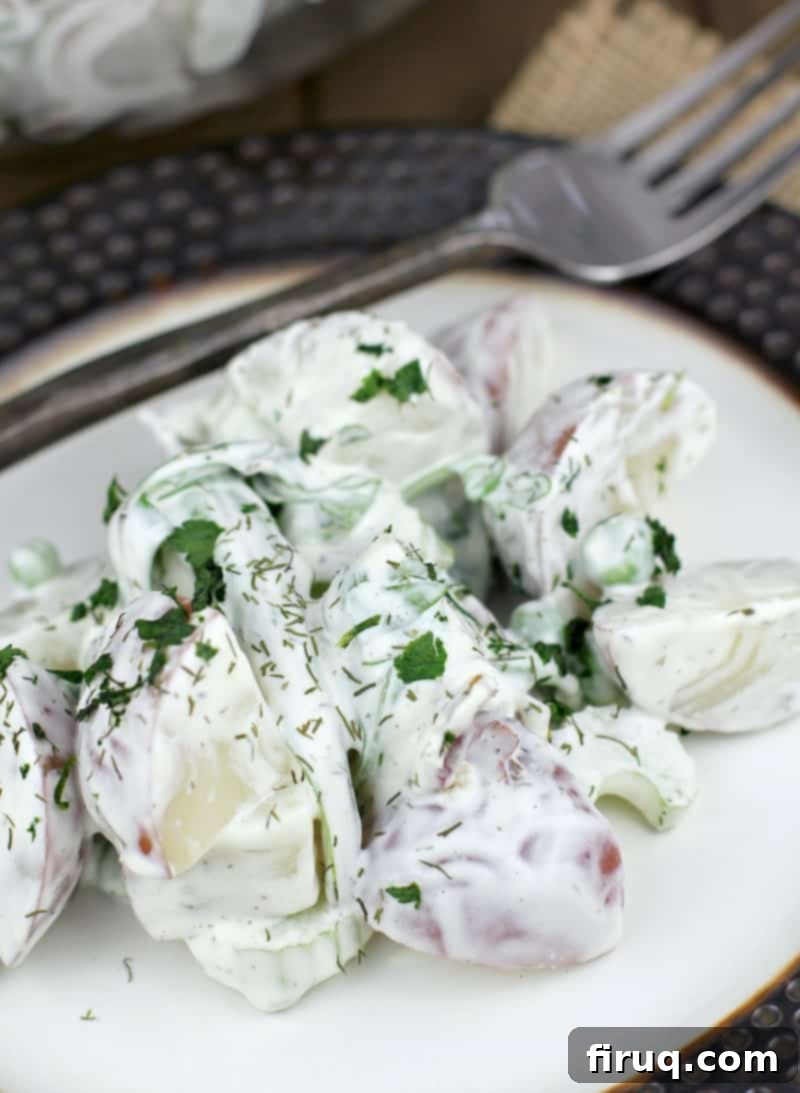 Spring Potato Salad with Zesty Dill 8 Plated spring potato salad with a rustic fork, ready to be eaten.