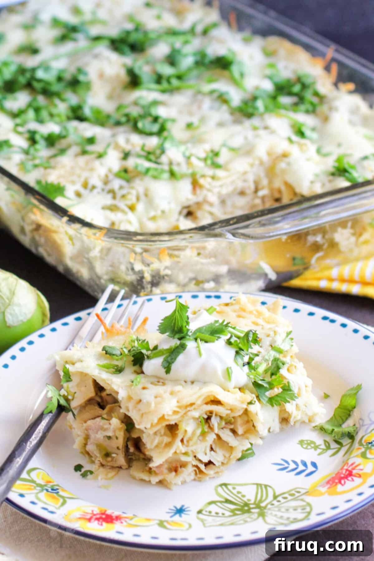 Stacked Chicken Enchiladas with Zesty Salsa Verde 2 serving of casserole on plate with fork