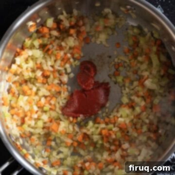 Rustic Italian Lentils 5 Tomato paste caramelizing in a saucepan.
