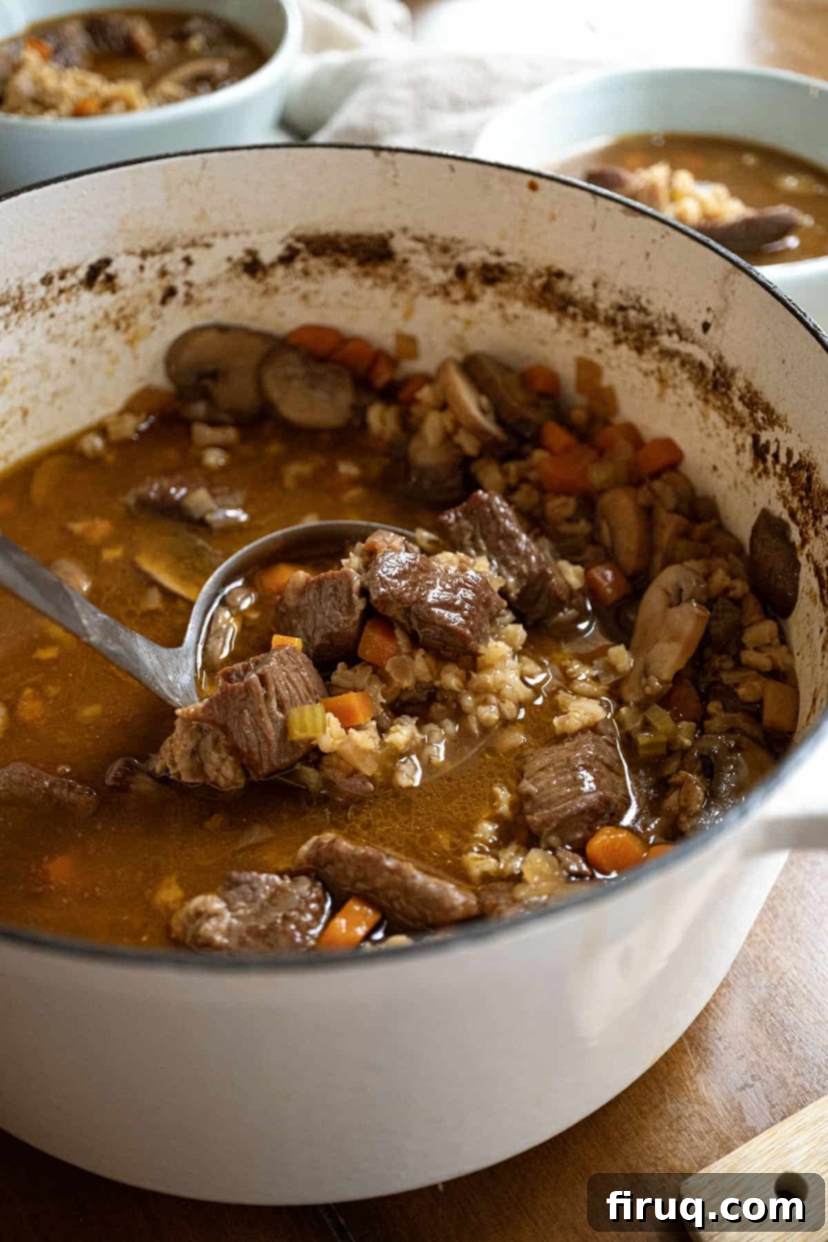 Hearty Beef Barley and Mushroom Soup 2 A large pot brimming with hearty beef and barley soup, ready to be served.