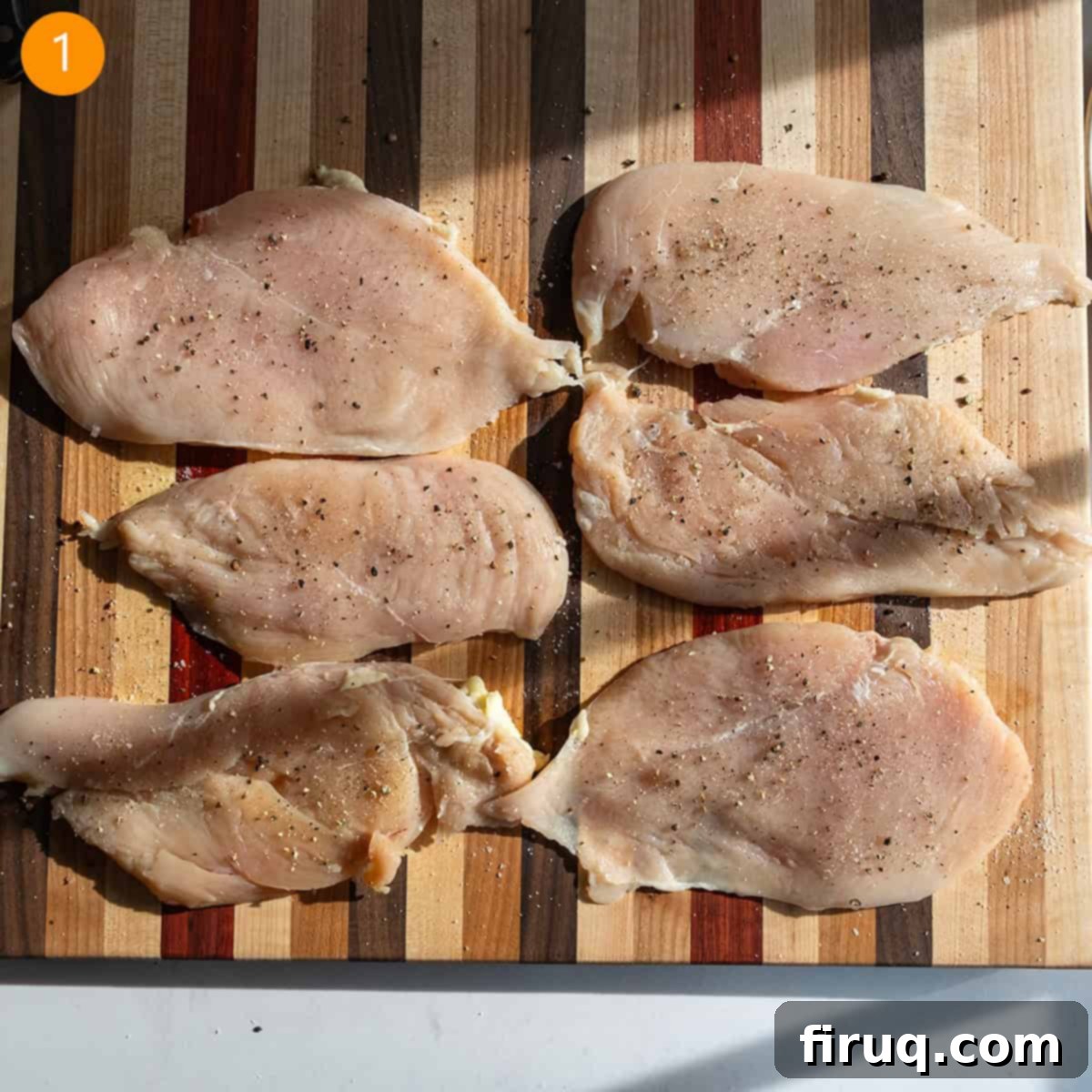 Perfect Homemade Chicken Piccata 4 Tenderized chicken breast seasoned with salt and pepper on a cutting board.