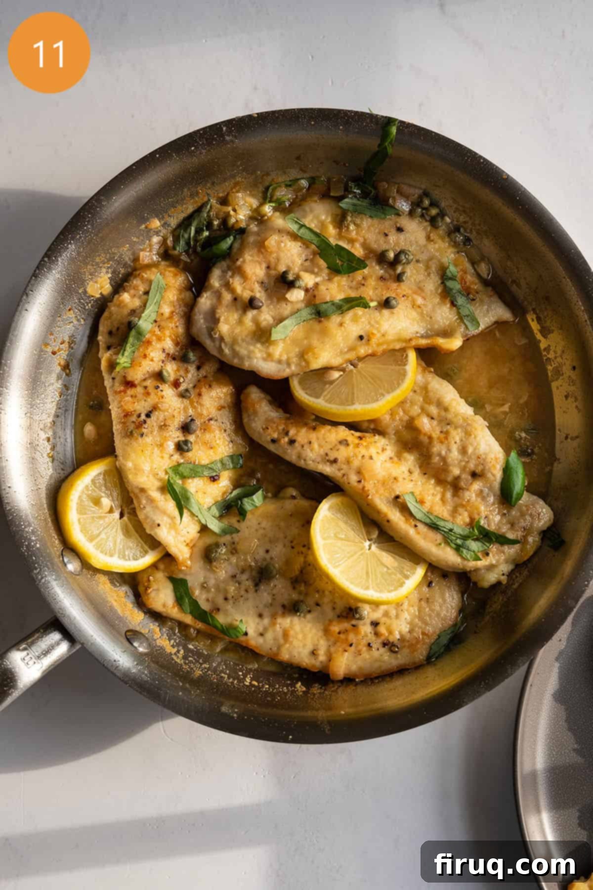 Perfect Homemade Chicken Piccata 9 Chicken piccata in sauce pan topped with basil and capers.