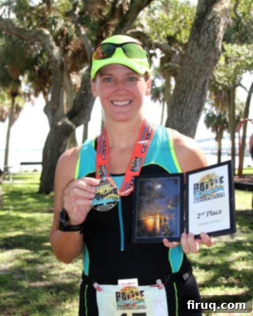 Tropical Pina Colada Pull-Apart Bread 5 The author smiling after completing a triathlon, proudly holding a medal and an award, symbolizing achievement.