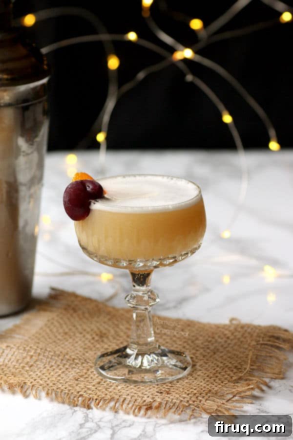 Garnished Amaretto Sour Amaretto Sour cocktail garnished with an orange twist and cherry.
